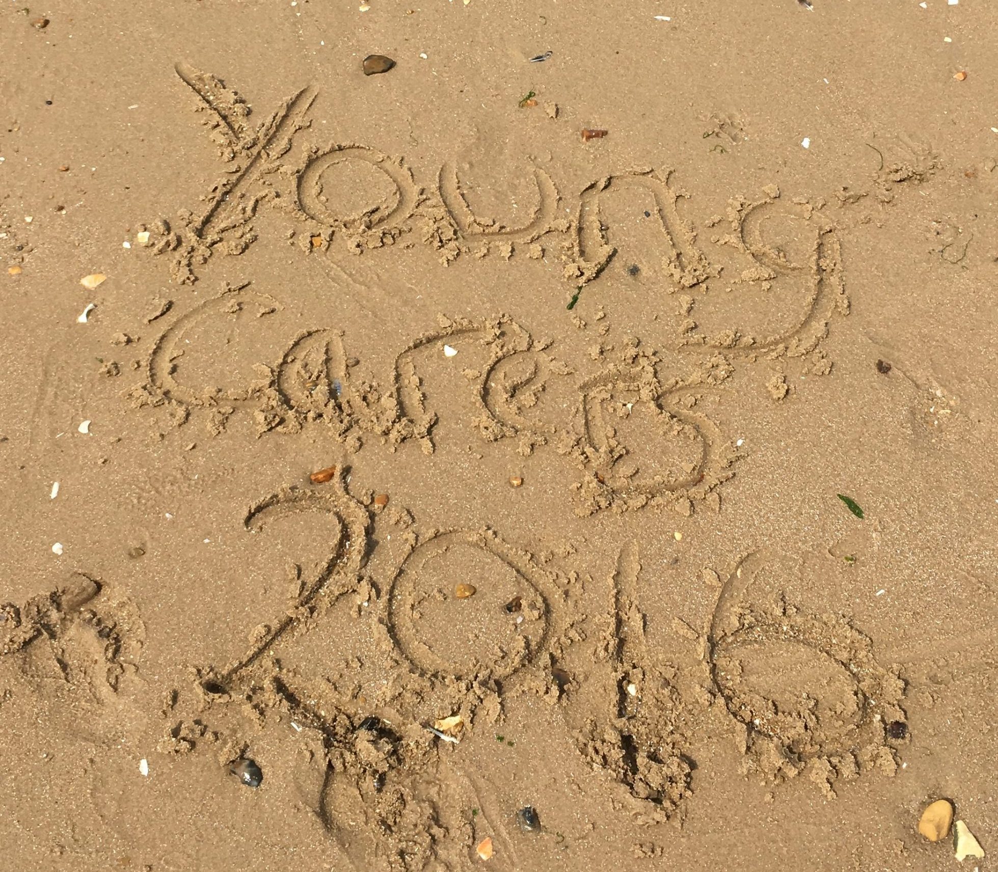 Young carers 2016 written in sand