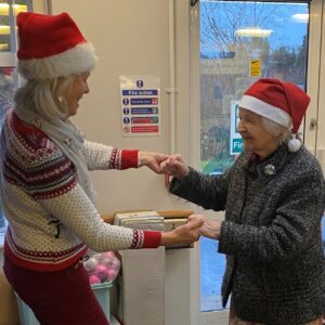 People in Christmas hats dancing