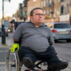 Man in a wheelchair travelling around town