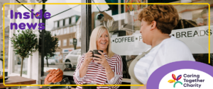 Female working carer chatting to a lady outside a café