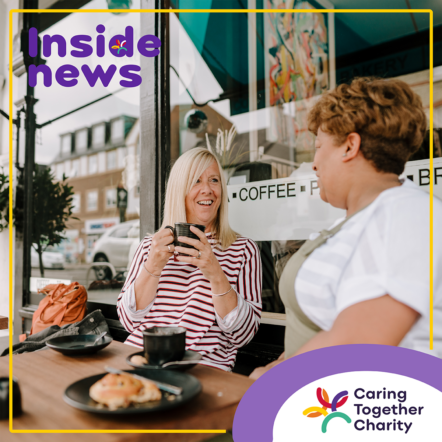 Female working carer chatting to a lady outside a café