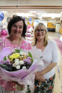 Kerry Giles-Brown care professional receives flowers from Miriam Martin CEO