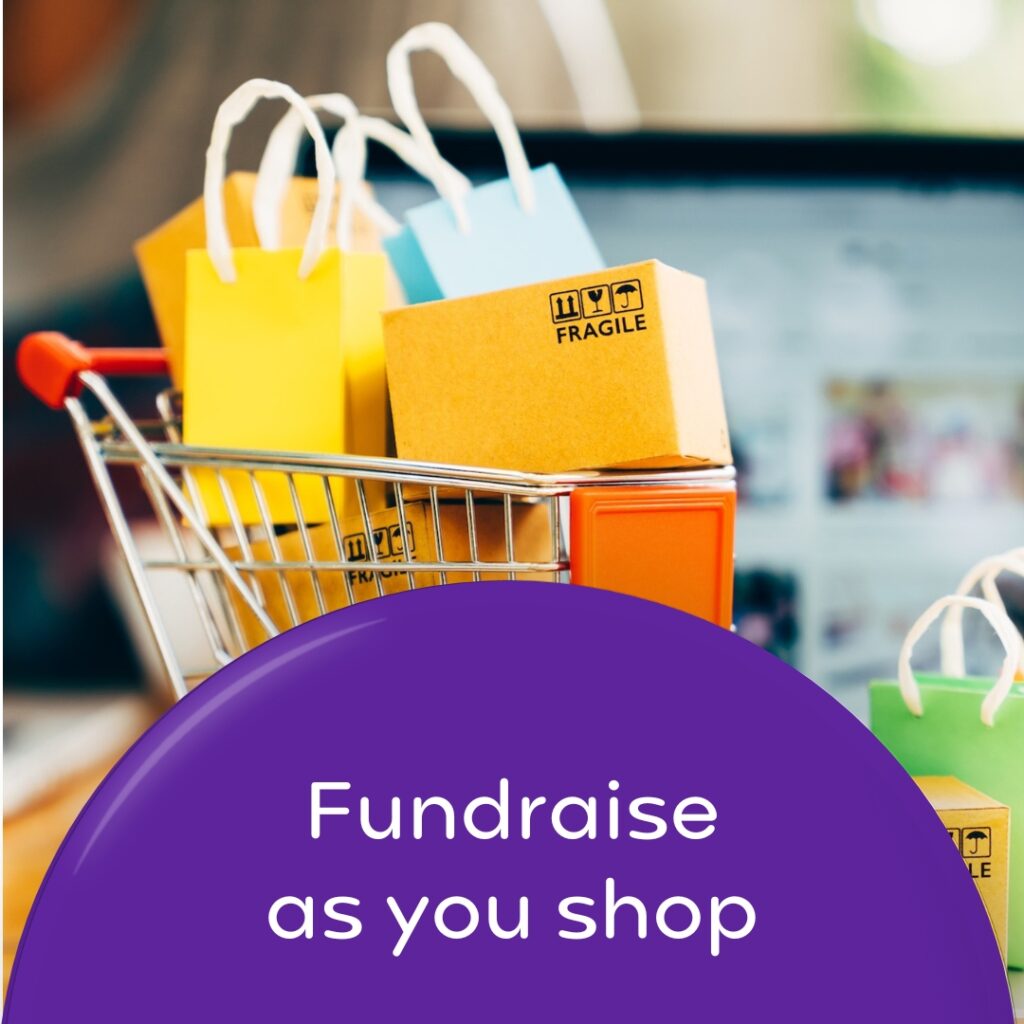 Fundraise as you shop wording with laptop in background and mini shopping trolley with bags in
