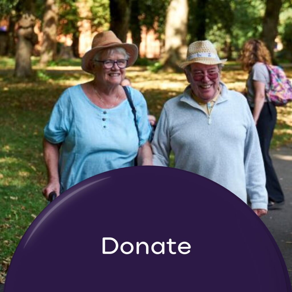 Donate wording with image of older man caring for wife