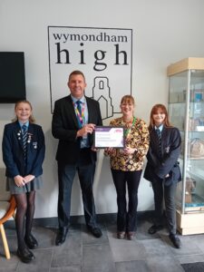 Staff and pupils at Wymondham High Academy with their Carer Friendly Tick Award - Education