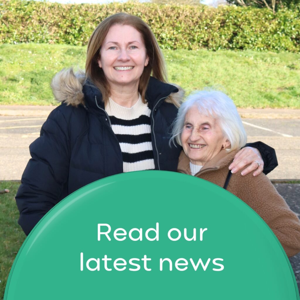 Daughter with her mum who she looks after. Wording 'Read our latest news'.