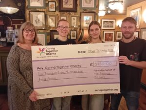 Staff at Ivo Lounge with fundraising cheque for Caring Together Charity