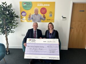 Ceres Lodge member Peter De-Gol (left) and Caring Together Charity senior fundraising manager Laura Price with a giant cheque for £1,000 raised by the lodge.