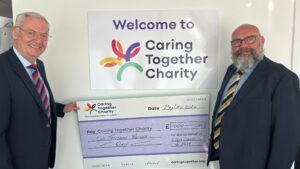 Ceres Lodge memeber Peter De-Gol (left) and Norfolk masonic community engagement officer Ian Betts with giant cheque for £1,000 raised for Caring Together Charity.