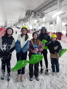 Young carers having fun at an indoor snow centre