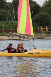 Young carers having fun sailing