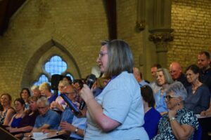 Community fundraiser Lynnette Ballantyne giving a presentation at the St Ives Community Choir summer concert at St Ives Free Church