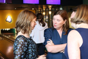 Young carer (left) talking to Children's Commissioner for England, Dame Rachel de Souza, at a bowling alley