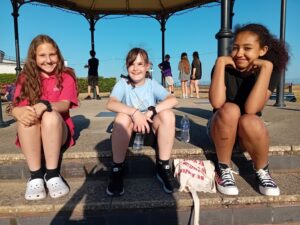 Three young carers sat on Gorleston seafront
