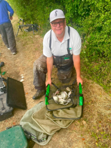 Angler Joff Woodgett with a net of fish he has caught during the fundraising fishing match for Caring Together Charity