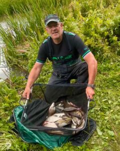 Angler Paul Greensmith with a net of fish he has caught during the fundraising fishing match for Caring Together Charity