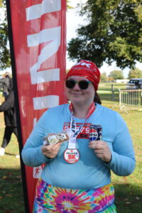 Caring Together Charity carer awareness and voice co-ordinator Claire Rogers holding a can of Pepsi Max and a piece of cake.