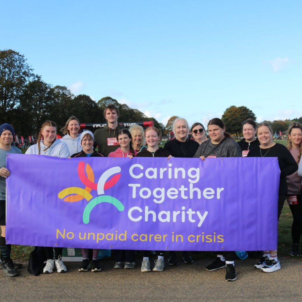 The Caring Together Charity team behind a Caring Together Charity banner.